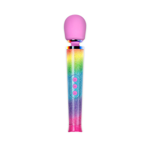 Le Wand Petite Massager in Rainbow Hombre. A long slightly wide handle in sparkly rainbow hombre colors, a narrower flexible neck, and rounded pink head. It has three buttons in the center of the handle.