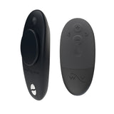 We-Vibe Moxie  remote controlled panty vibrator in black. A three inch vibrator with a flat back  and rounded bottom. A small magnet attaches to the back. One button on the back. the small black remote control has four buttons.