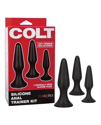 COLT Silicone Anal Trainer Kit. Three black butt plugs in small, medium, and large with tapered tips, neck, and round flared base. A red and black box with a picture of the plugs and the words COLT silicone anal trainer kit