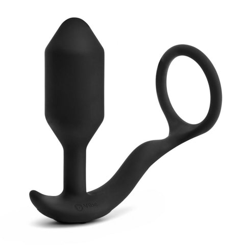B-Vibe Vibrating Snug & Tug (XL). A thin cock ring and large cylindrical butt plug with a slightly pointed tip and narrow neck, connected by a thick silikcone cord. In black.