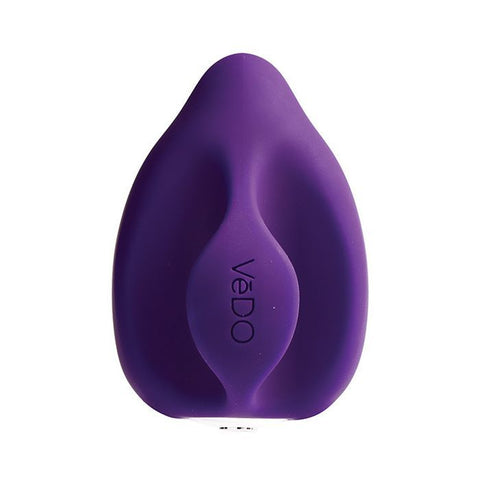 VeDO Yumi finger vibrator in dark purple. A small, round vibrator with a smaller round tip. The back of the vibe has a fin that goes between two fingers so the user doesn’t have to grip the toy while using it.