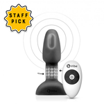 B-vibe Rimming Plug Petite. A black butt blug with a rounded tip, narrower neck showing rotating beads inside, and a rectangular flared base. Beside it is a white and black remote control that says b-vibe.