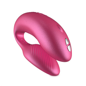 We-Vibe Chorus couple’s vibrator in pink. A small, adjustable, horseshoe shaped toy with one end slightly larger than the other. One button control on the larger end. Remote control has 4 buttons.