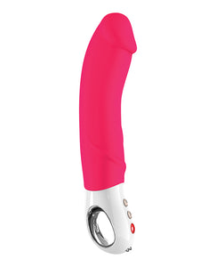 Fun Factory Big Boss Vibrator in pink. A long, thick semi-realistic shaft and short white plastic handle with a long hole for fingers to go through and three buttons on the front.