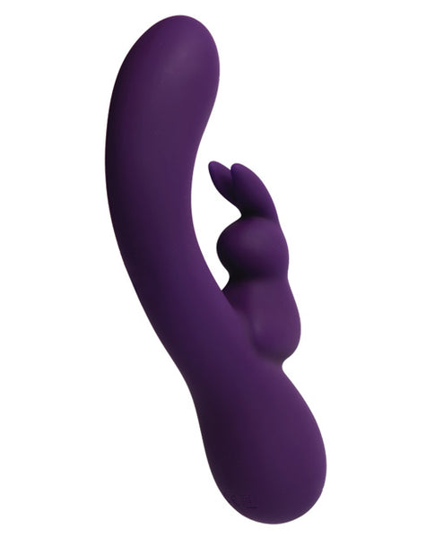 VeDO Kinky Bunny dual stimulation vibrator in dark purple. A sharply curved shaft with round tip has a bunny attachment at the center for clitoral stimulation. There are two button controls on the bottom third.